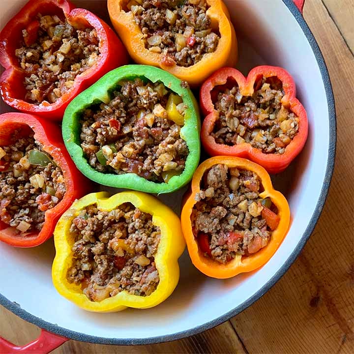 A top down view of a dutch oven filled with Keto stuffed bell peppers