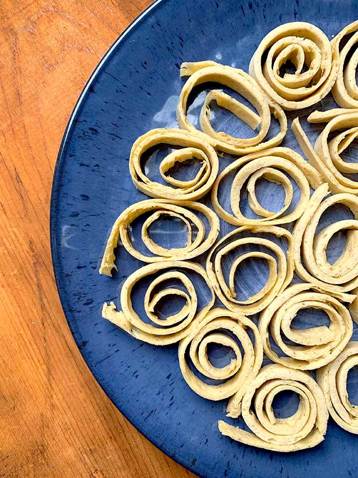 spirals of keto Psyllium Husk noodles on a blue plate