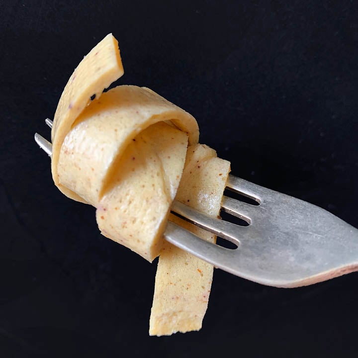 a forkful of low carb Psyllium Husk noodles against a black background