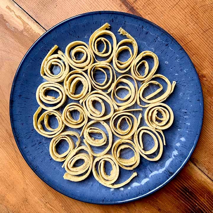 a top down view of a blue plate filled with keto psyllium husk noodles.