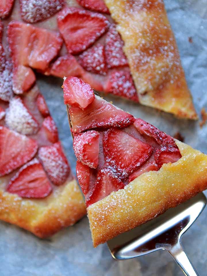 a server picks up a slice of Keto pastry with strawberry filling
