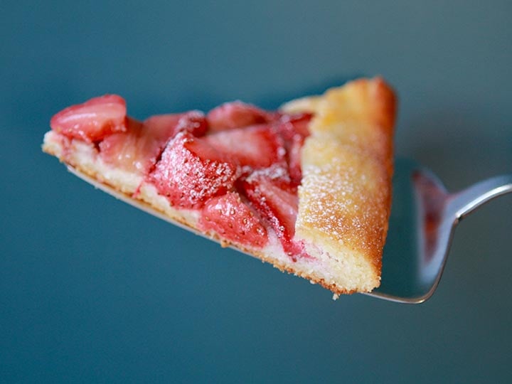 a slice of gluten free strawberry pastry against a blue background