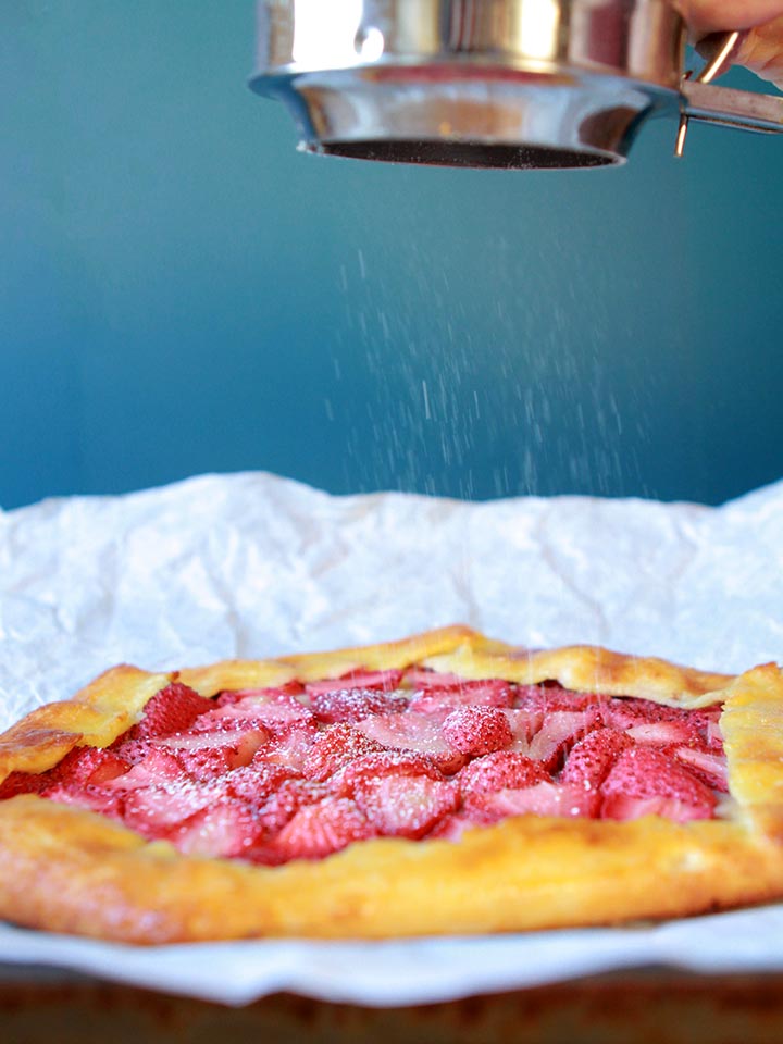 a sprinkle of powdered Swerve falls on a sugar free strawberry dessert