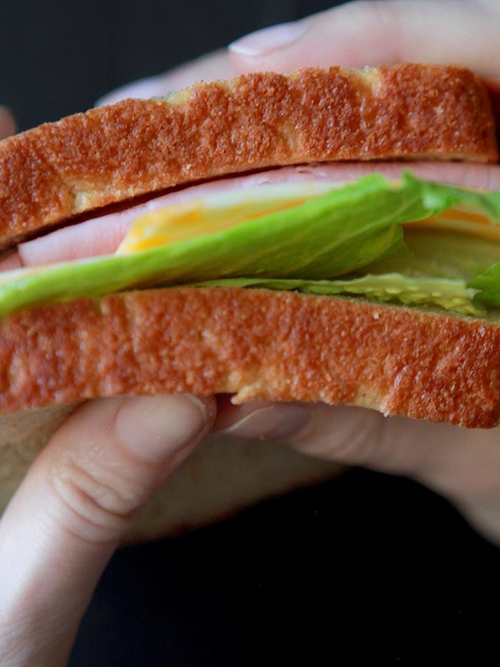 two hands hold a low carb sandwich.