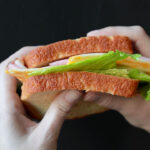 two hands hold a low carb sandwich