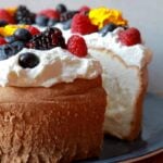 a Keto Angel Food Cake with a slice cut out of it