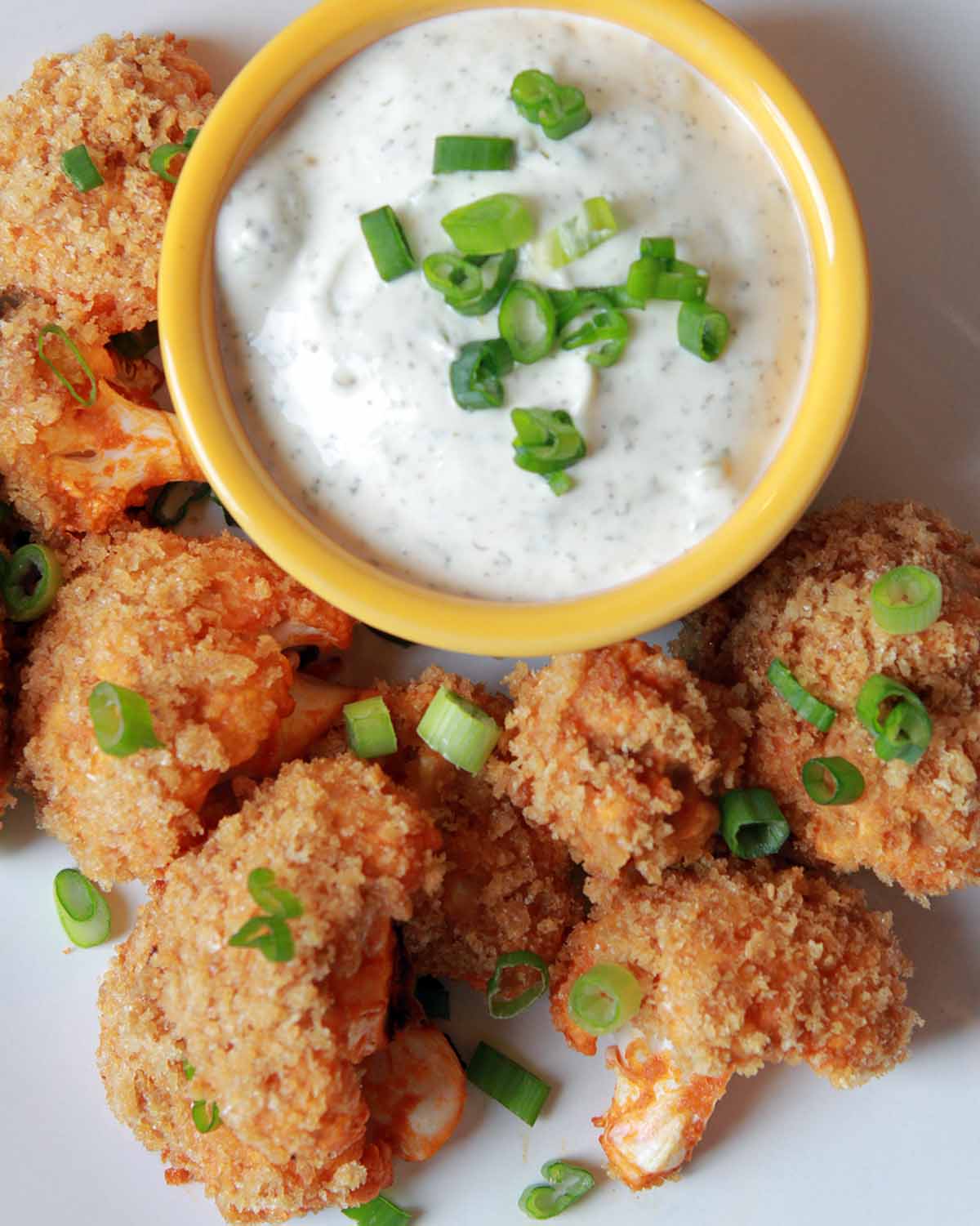 a plate full of low carb buffalo cauliflower with ranch dip
