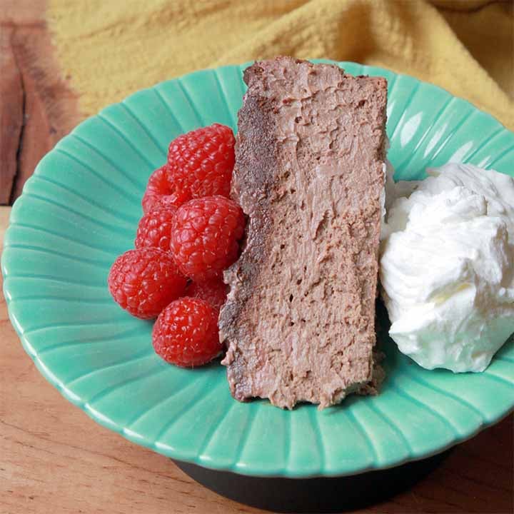 a slice of low carb chocolate cheesecake on a green plate