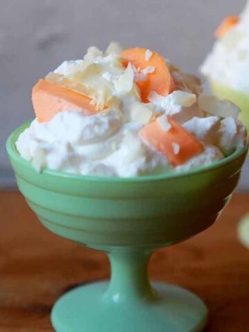 a green bowl of Keto Orange Fluff Jello Salad