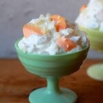 2 bowls of whipped cream and orange Jello slices