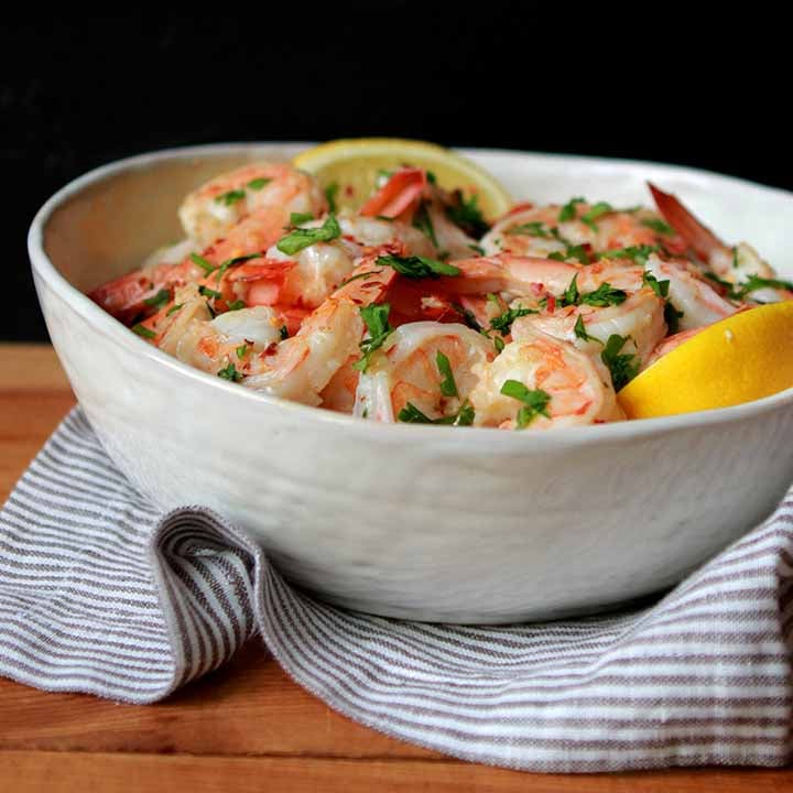 a white bowl filled with Keto Shrimp Scamp against a black background