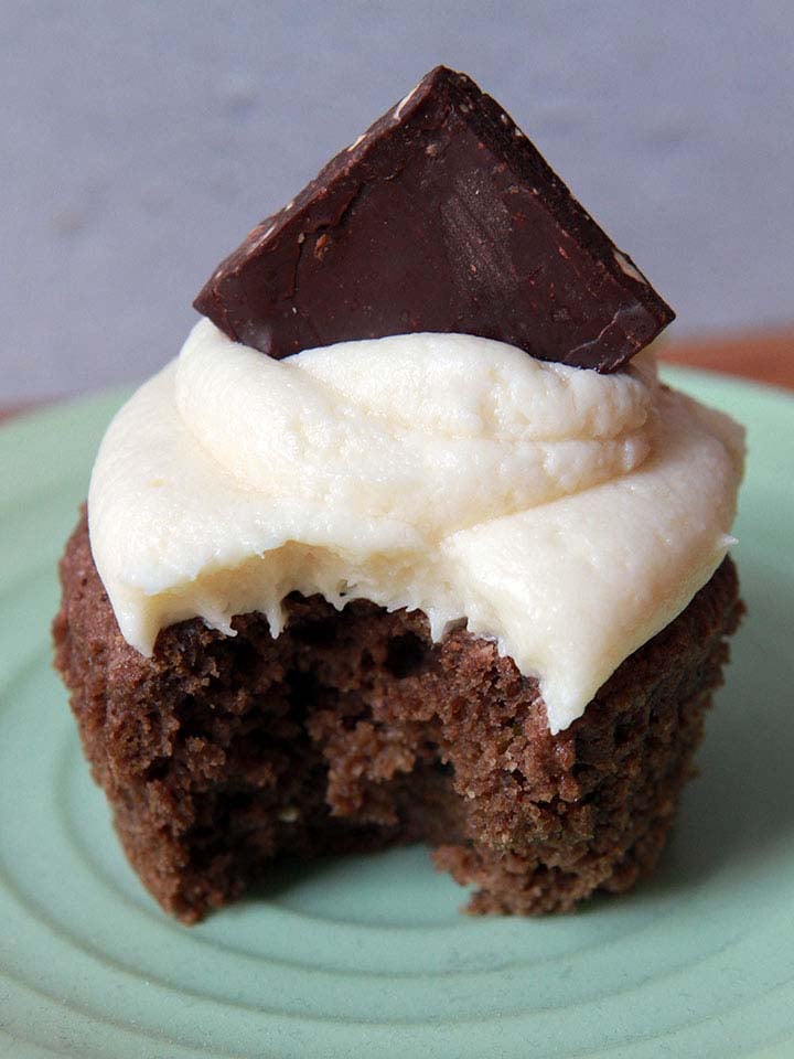 a Keto almond bark topped chocolate cupcake with a bite taken out of it