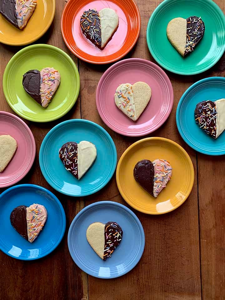 muliti-color plates holding gluten-free shortbread heart cookies