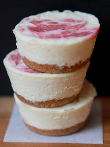 a stack of 3 Keto raspberry swirl mini cheesecakes