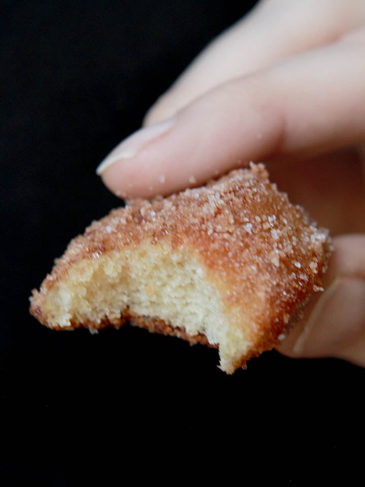 a hand holds a sugar free pretzel nuggets with a bite taken out