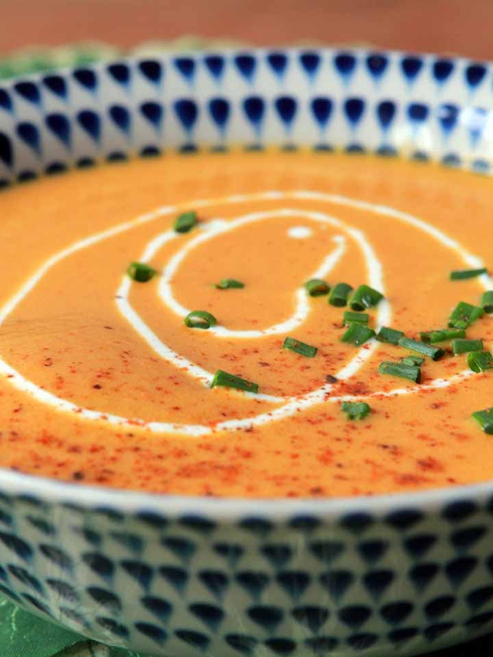 a side view of a bowl of creamy vegetarian carrot soup
