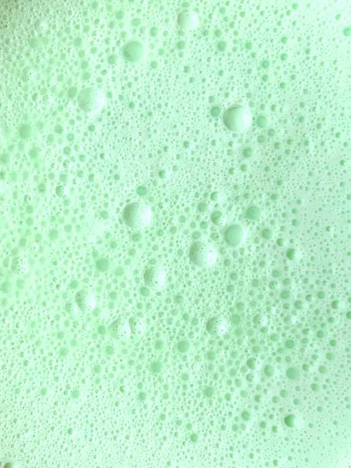 a close up of the surface of green low carb Jello whips