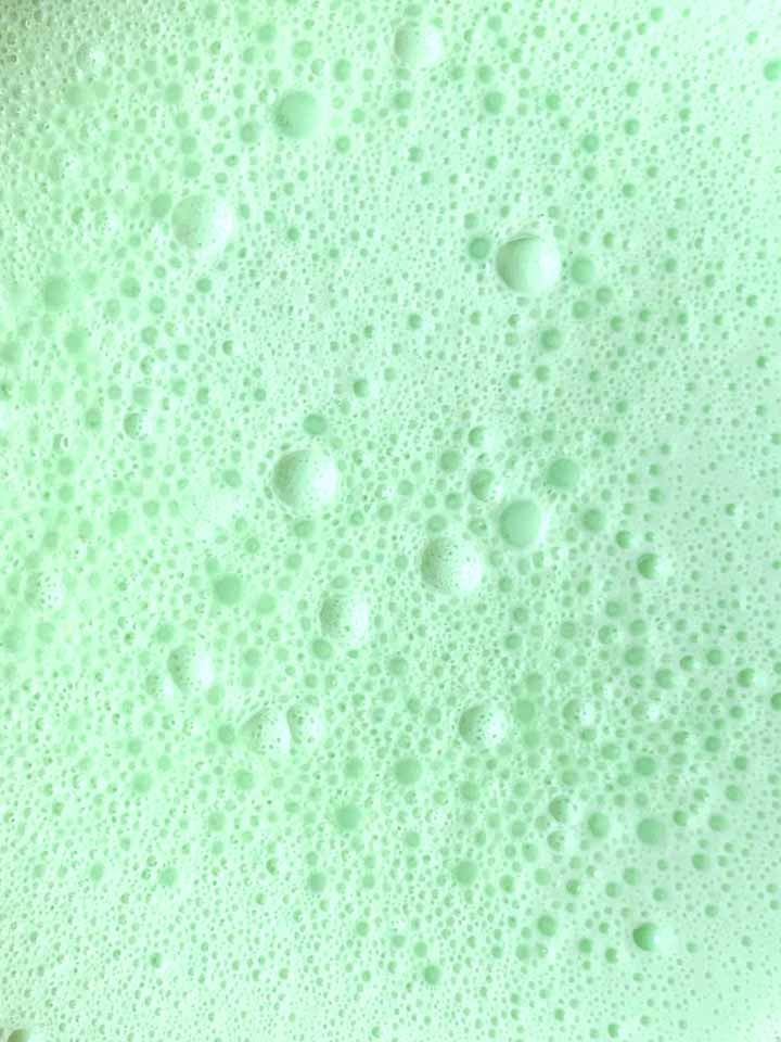 a close up of the surface of green low carb Jello whips