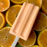 A Keto orange creamsicle against a background of oranges