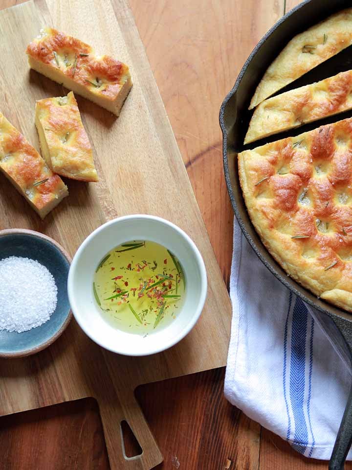 a top down view of a pan of keto focaccia with salt and olive oil