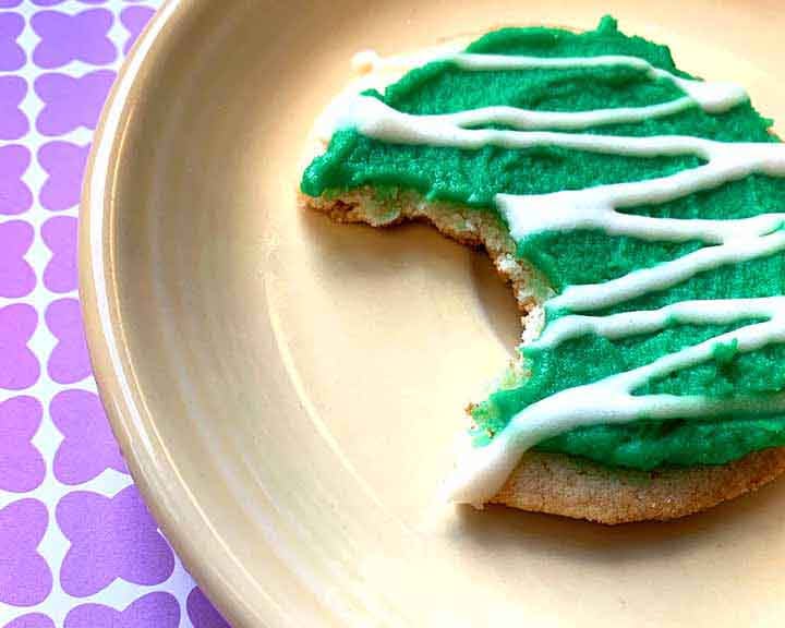 a gluten-free Christmas Cookie on a plate with a bite taken out of it