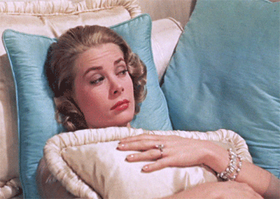 a gif of Grace Kelly lounging on a sofa