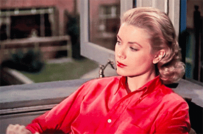 a gif of Grace Kelly reading a magazine