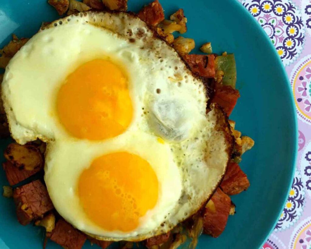 a top view of a plate of Keto Corned Beef and Over Easy Eggs