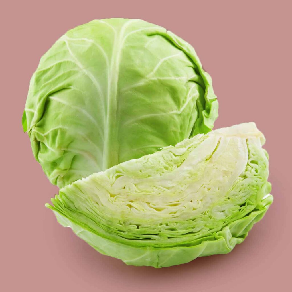 a cabbage against a pink background
