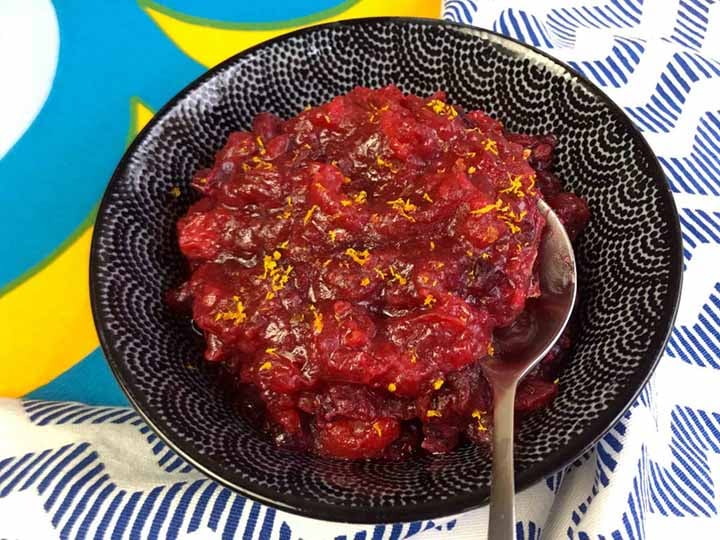 a spoon in a bowl of Keto Cranberry Sauce