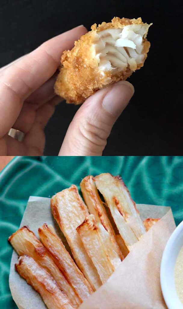 a hand holds a fish stick and chips are below