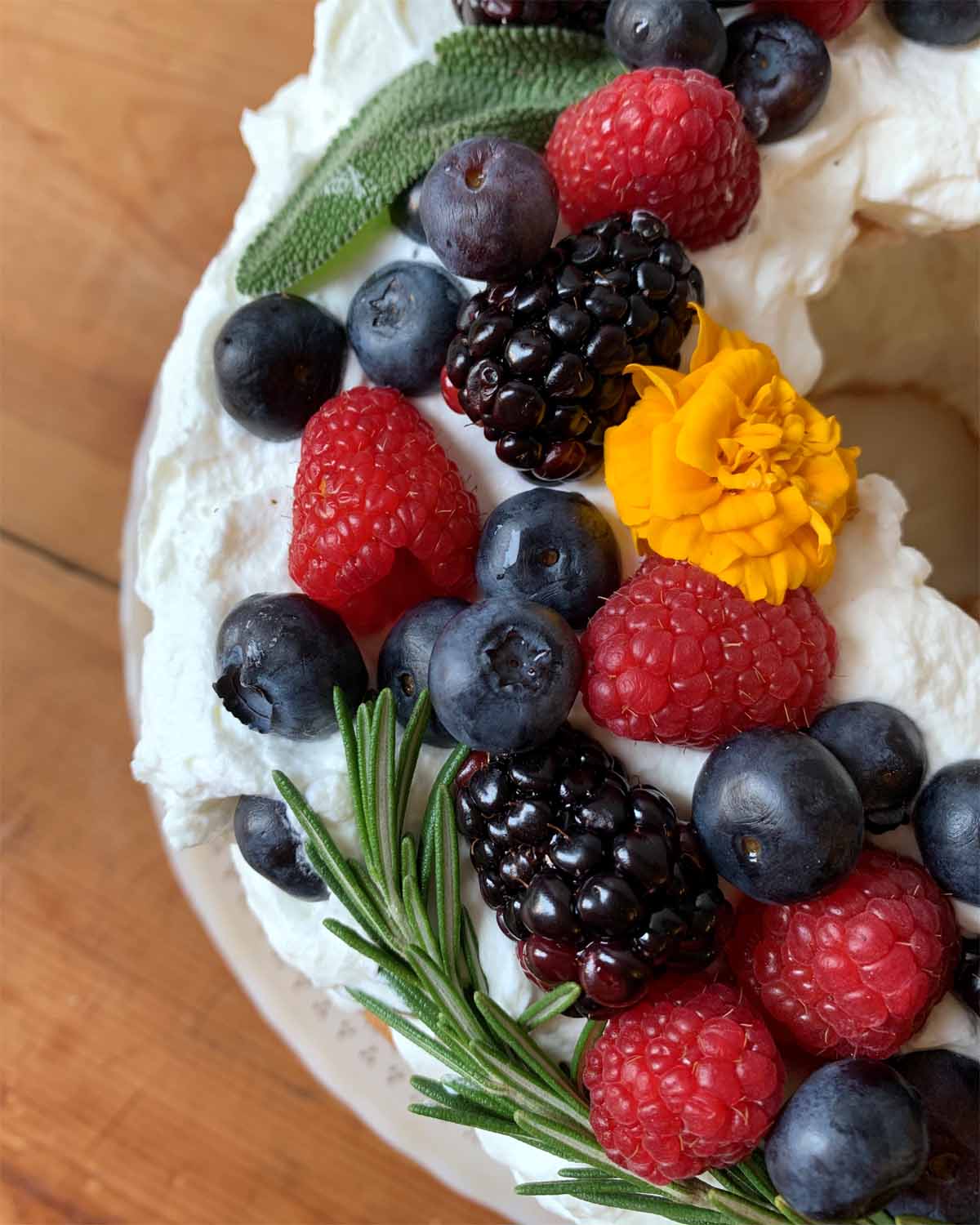 close up of berries, sage, thyme  and edible yellow flowers