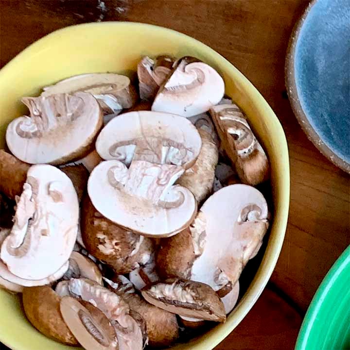 a bowl of button mushrooms for the low carb Beef Stroganoff