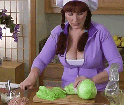 a gif of a hearty Russian woman cooking while a random chicken walks by