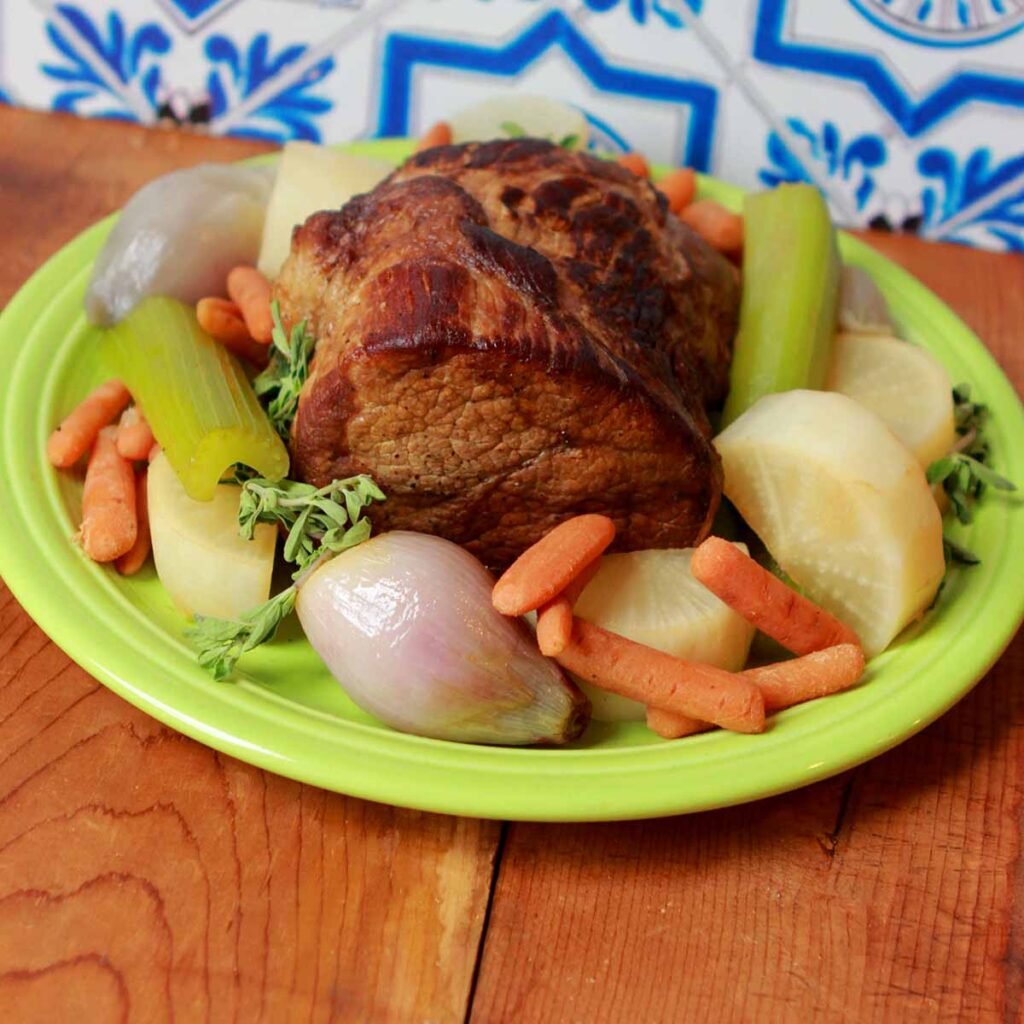 a Rump Roast Instant Pot recipe with vegetables on a green platter