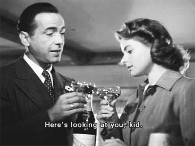 a gif of Humphrey Bogart clinking glasses with Ingrid Bergman in Casablanca
