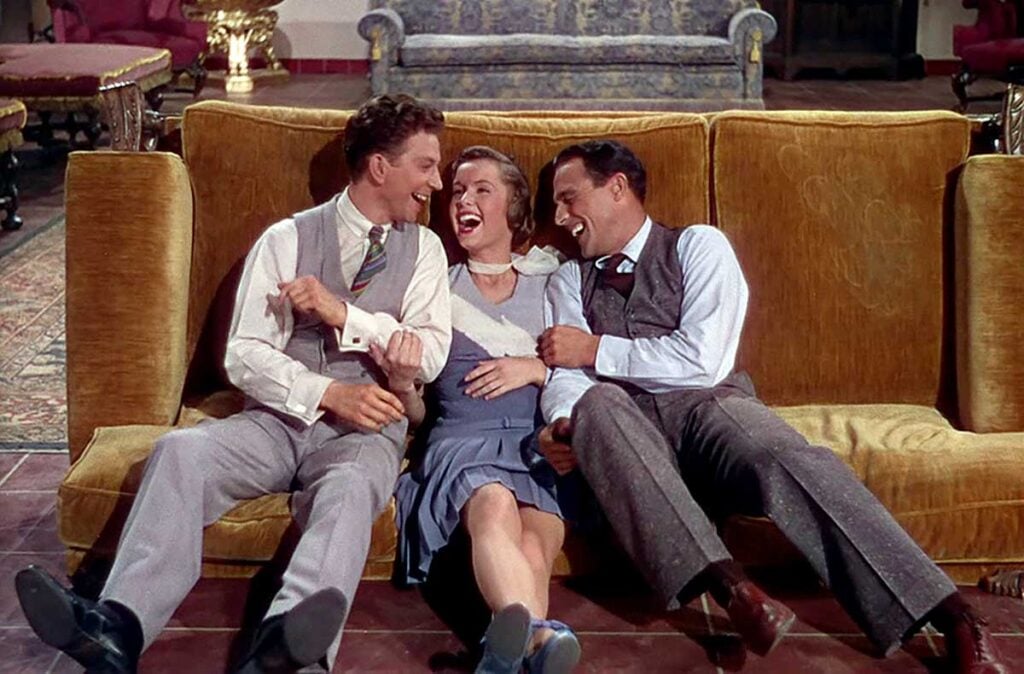 cast of Singing in the Rain flopped down on a sofa