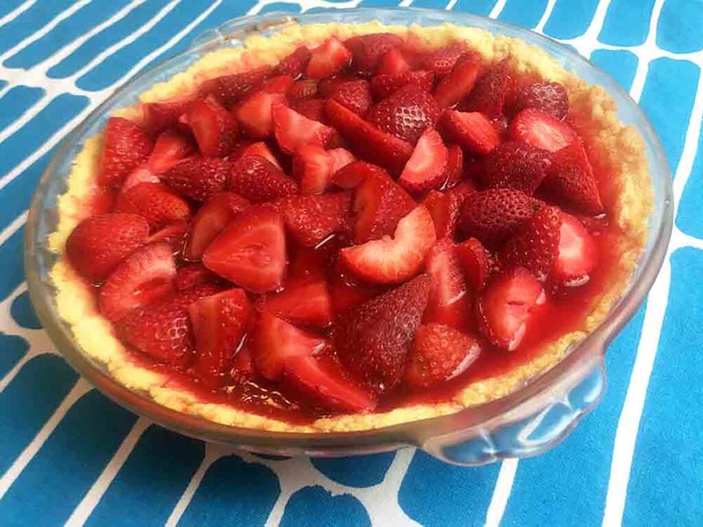 a Keto Strawberry Pie against a blue patterned cloth