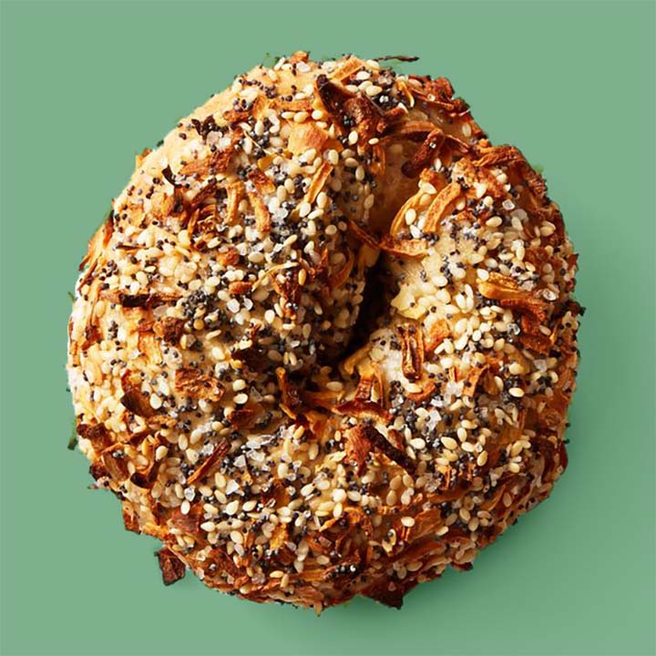 a classic everything bagel against a green background