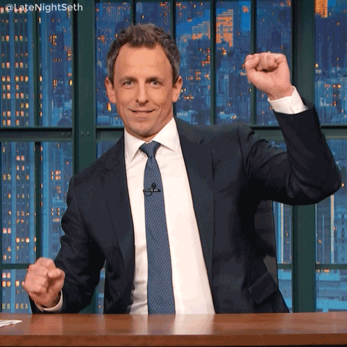 a gif of seth meyers doing a happy dance