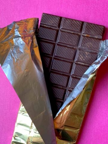 a Keto Candy Bar against a pink background