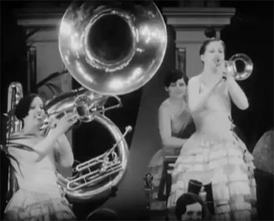 1920s flappers playing horns in a band