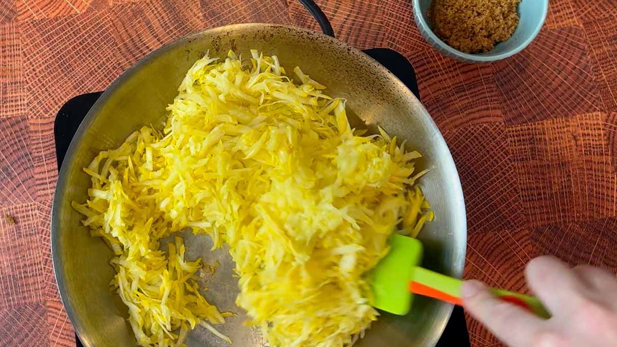 sauting yellow squash in a pan