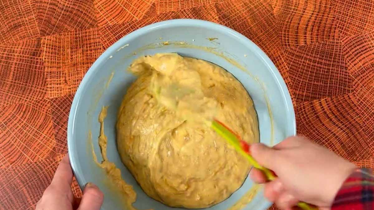 a hand mixes the batter