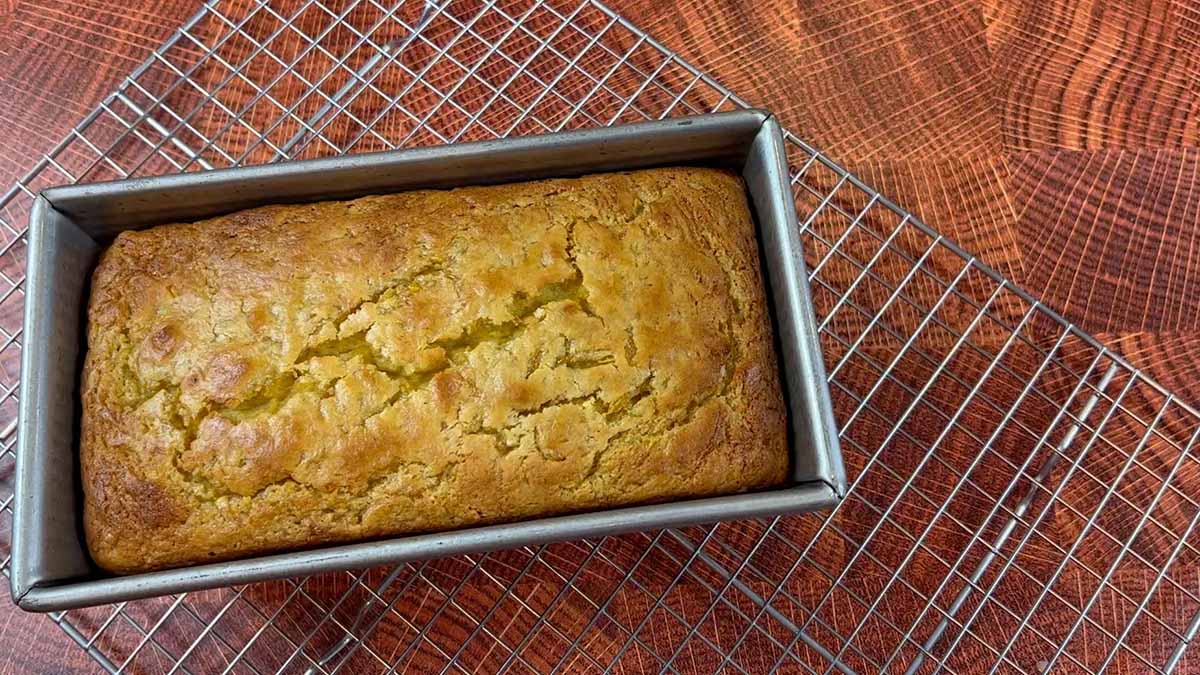 a pan of banana bread cooling on a rack