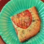 a green plate with a Focaccia Carbquik Recipe