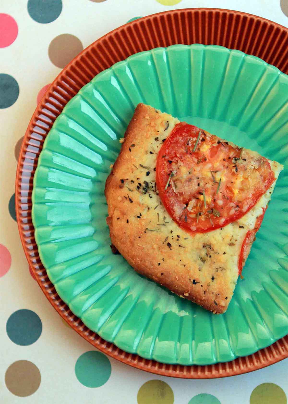 A slice of Carbquik  focaccia on a green plate.