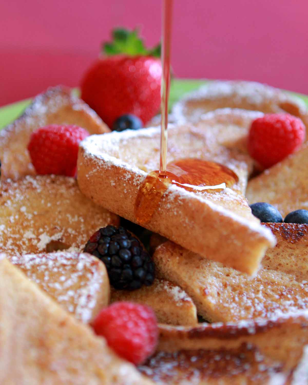 syrup pours on Keto French Toast with berries