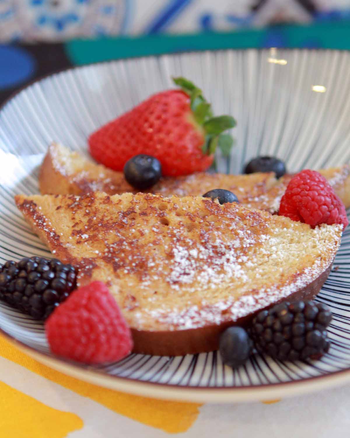 2 slices of Keto French Toast on a striped plate