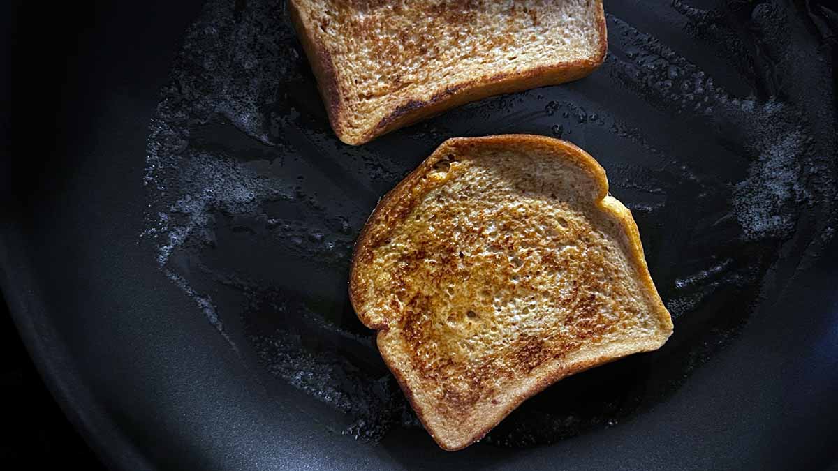 2 sliced of bread frying in the butter